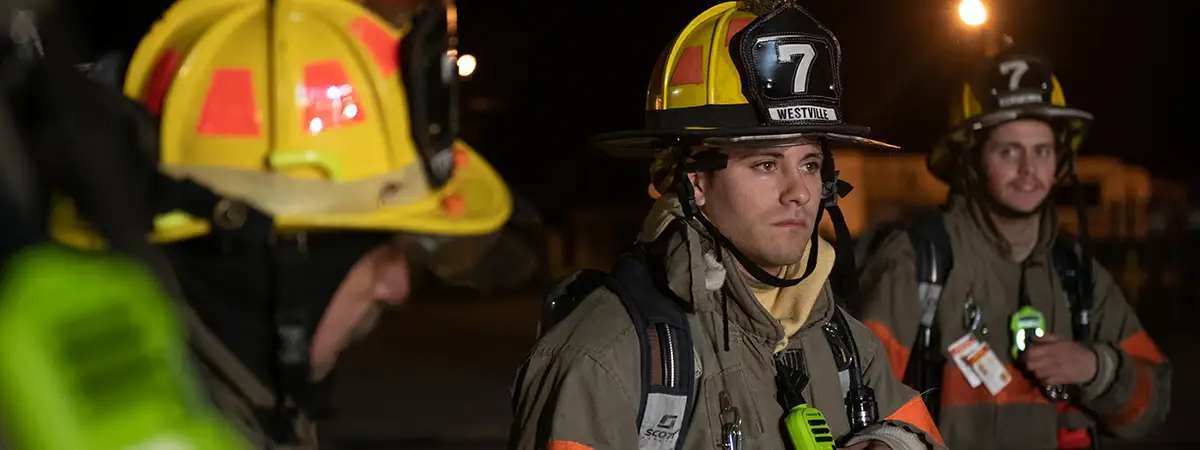 Young volunteers in full firefighting gear